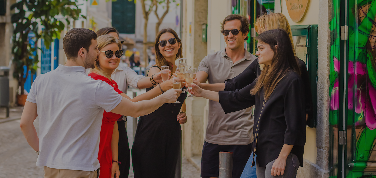 Group in Lisbon toasting with wine outside