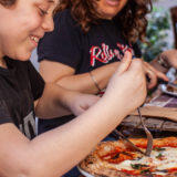 Child eating Neopolitan pizza