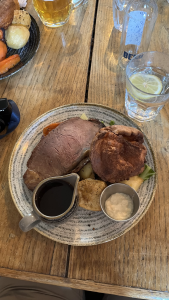 A sunday roast, sitting on a wooden table