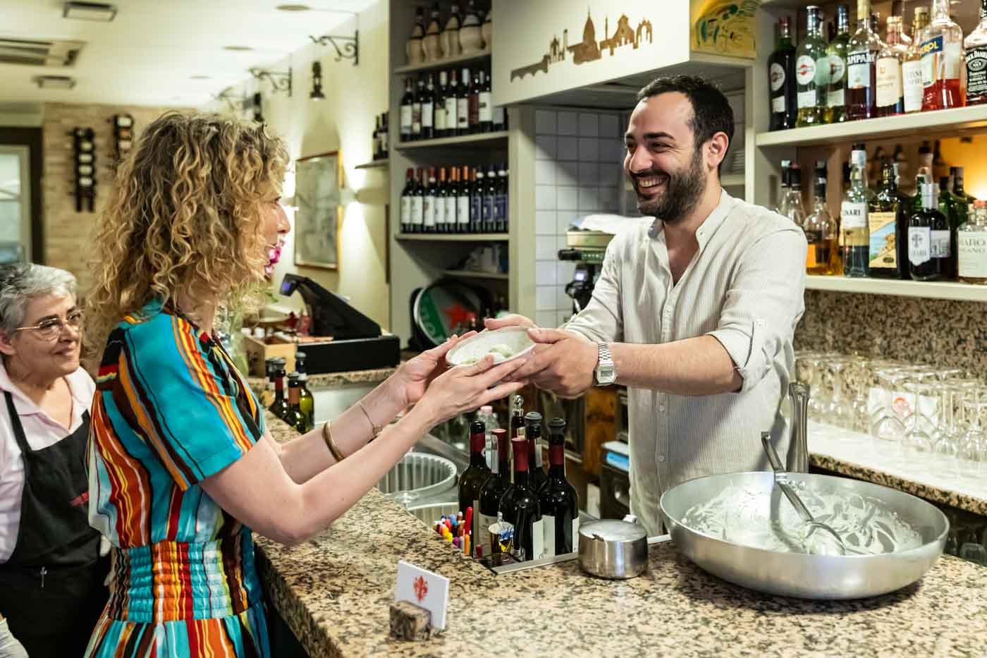 Woman_being_served_food_Trattoria_da_Ginone_Florence